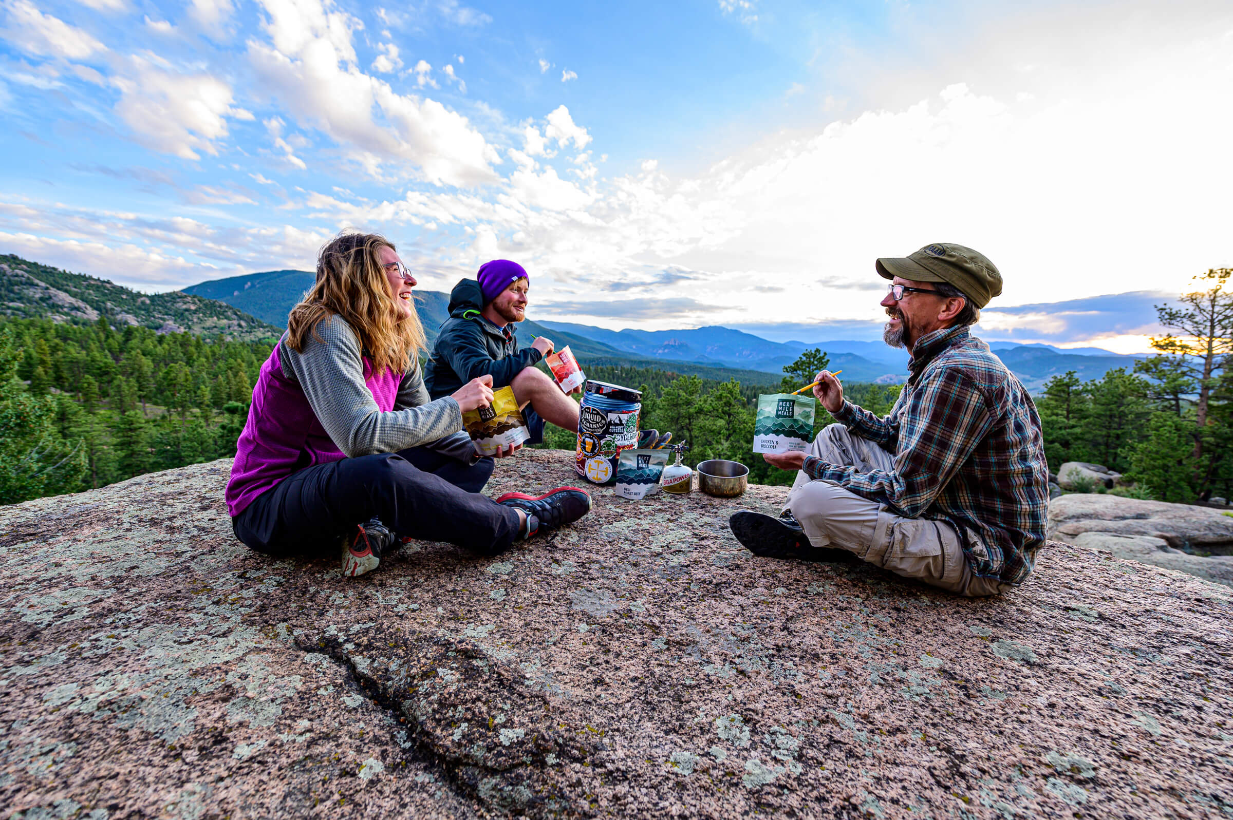 backpacking meals being eaten by a group of campers on a mountain